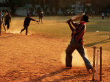 Cricket Batsman Swings on Dusty Pitch, Fort Cochin, India Fotografisk tryk af Anthony Plummer