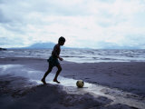 Boy Kicking Soccer Ball on Beach, Lake Nicaragua, Granada, Nicaragua Photographic Print by Eric Wheater