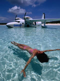 Female Floating in Crystal Waters in Front of Seaplane, Bahamas Photographic Print by Greg Johnston