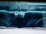 Ornamental Dice Hanging from the Rear Vision Mirror of a Classic Car on Route 66, Arizona, USA Photographie par Ray Laskowitz
