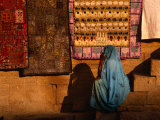 Woman in Sari Sitting in Front of Rugs for Sale, Jaisalmer, Rajasthan, India Photographic Print by Dallas Stribley