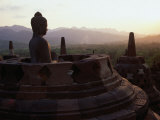 Statue of Buddha at Dusk Borobudur, Java, Central Java, Indonesia Photographie par Glenn Beanland