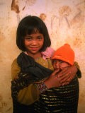 Young Koho Child Holding Baby at "Chicken Village," Lam Dong, Vietnam Photographic Print by John Banagan