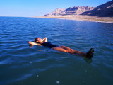 Woman Floating in Dead Sea Waters, Israel Photographic Print by Lee Foster