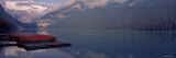 Red Canoes Stationed on a Pier, Lake Louise, Banff National Park, Alberta, Canada Photographic Print by Panoramic Images 