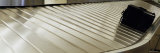 Luggage on an Airport Carousel Lámina fotográfica por Panoramic Images Luggage on an Airport Carousel Lámina fotográfica por Panoramic Images