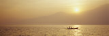 Silhouette of a Fishing Boat in a Lake at Sunrise, Lake Garda, Italy Photographic Print by Panoramic Images