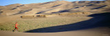 Woman Running in the Desert, Great Sand Dunes National Monument, Colorado, USA Lámina fotográfica por Panoramic Images