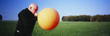 Mature Man Blowing a Balloon, Germany Photographic Print by Panoramic Images 