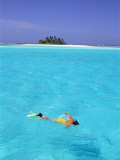 Woman Snorkelling at Sea Surface,Cocos Keeling Island in Background, Indian Ocean, Australia Posters by Jurgen Freund