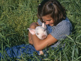 Girl Holding Domestic Piglet, Mixed Breed, USA Photo by Lynn M. Stone