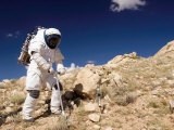 Astronaut Stands Beside a Core Sampling Tool on the Edge of Meteor Crater During Desert Rats Photographic Print by Stocktrek Images 