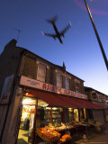 Aeroplane Above Shop, Hounslow, Greater London, England, United Kingdom Photographic Print by Charles Bowman