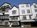 Shops in Tudor Buildings, Cathedral Green, Exeter, Devon, England, United Kingdom Photographic Print by Jean Brooks