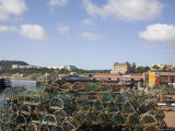 Lobster Pots by Old Harbour in South Bay with Hotels on South Cliff Beyond, North Yorkshire, UK Photographie par Pearl Bucknall
