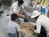 Playing a Board Game, Barkhor, Lhasa, Tibet, China Photographie par Ethel Davies