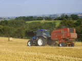 Tractor Collecting Hay Bales at Harvest Time, the Coltswolds, England Photographic Print by David Hughes