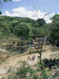 Houses and People Walking in Dry River Bed Caused by Erosion, Near Petionville, Haiti, West Indies Photographic Print by Lousie Murray