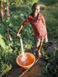Boy at Water Tap, Chuka Village, Mount Kenya, Kenya, East Africa, Africa Photographic Print by Duncan Maxwell