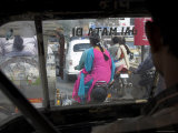 Women Riding on Back of Motorcycles in Heavy Traffic Viewed from Inside a Motor Rickshaw Photographic Print by Eitan Simanor