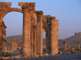 Monumental Arch at Archaeological Site, with Arab Castle Beyond, Palmyra, Syria Photographic Print by Bruno Morandi