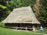 Tourists Visiting Traditional Thatched Roof House in the Museum of Folk Architecture and Rural Life Photographic Print by Christian Kober