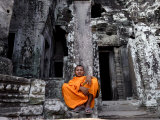 A Buddhist Monk Relaxes in the Bayon Temple, Angkor, Unesco World Heritage Site, Cambodia Photographic Print by Andrew Mcconnell
