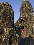 A Couple Rest Beneath the Giant Faces of the Bayon Temple, Angkor, Cambodia Photographic Print by Andrew Mcconnell