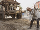 Man in Topi Hat Takes Part in the Annual Construction of a Chariot for a Religious Festival Fotografisk tryk af Don Smith