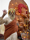 Holy Man in Front of a Ganesh Statue Draped in Fairy Lights at the Hindu Festival of Shivaratri Photographic Print by Don Smith