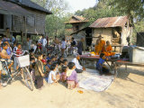 Monks and Villagers Watching Television Outside Farmhouse, Rakar Village, Battambang, Indochina Photographic Print by Jane Sweeney