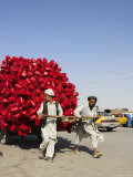 Men Pulling Wooden Cart Piled with Red Water Containers Along Road, Balkh Province, Afghanistan Photographic Print by Jane Sweeney
