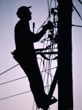 Silhouette of Engineer Working up a Telegraph Pole, East Sussex, England, United Kingdom Photographic Print by Ruth Tomlinson