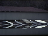 Canoes Reflected in Water at a Boat Landing Reprodukcja zdjęcia autor Sam Abell