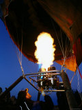 Man Operating a Flame to Fill a Hot-Air Balloon, Goreme, Nevsehir, Turkey Lámina fotográfica por John Elk III
