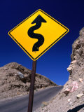 Sign Warning of a Curvy Road, Near the Artist's Palette, Nevada Fotografisk trykk av Dominic Bonuccelli Sign Warning of a Curvy Road, Near the Artist's Palette, Nevada Fotografisk trykk av Dominic Bonuccelli