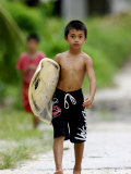 Young Local Boy Heading Out for Afternoon Surf, Lagundri Bay, Pulau Nias, North Sumatra, Indonesia Fotografisk tryk af Paul Kennedy