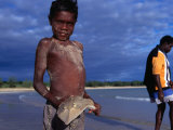 Young Aboriginal Boy with Shovel Nose Fish, Aurukun, Cape York Peninsula, Queensland, Australia Photographic Print by Oliver Strewe