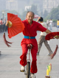 Fan Fluttering Unicyclist on the Bund Promenade, Shanghai, China Photographic Print by Greg Elms