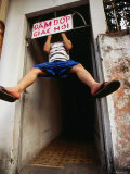 Man Doing Pull-Up on Sign Advertising Cupping Massage, Ho Chi Minh City,  Vietnam Photographic Print by Stu Smucker