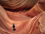 Man Walking through the Wave Formation, Vermillion Cliffs National Monument Photographic Print by Mark Newman
