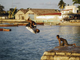 Children Diving in Sea at Waterfront, Stone Town, Zanzibar Town, Zanzibar West, Tanzania Photographic Print by Ariadne Van Zandbergen