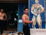 Weight Lifter Flexes at Facility Inside Cao Dai Temple Complex, Tay Ninh, Vietnam Photographic Print by Stu Smucker