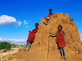 Three Young Maasai Goat Herds on a Termite Mound, Longido, Arusha, Tanzania Photographie par Ariadne Van Zandbergen