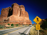 Road Sign in Front of Courthouse Towers, Arches National Park, Utah Photographic Print by David Tomlinson