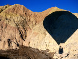 Shadow of Hot-Air Balloon over Barren Landscape Near Goreme, Cappadocia, Nevsehir, Turkey Photographic Print by John Elk III