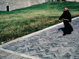 Priest Walks Past a Grassy Lawn in Assisi, Umbria, Italy Photographic Print by Jeffrey Becom