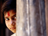 Girl with Forehead Marking Peering from Behind Pillar, Rajasthan, India Photographic Print by Daniel Boag