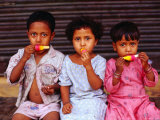 Three Children Eating Icy-Poles, Bengali Basti, Delhi, India Fotografisk trykk av Daniel Boag Three Children Eating Icy-Poles, Bengali Basti, Delhi, India Fotografisk trykk av Daniel Boag