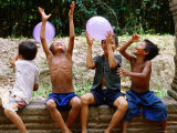 Local Boys Toss Balloons Outside Preah Kahn Temple, Siem Reap, Cambodia Photographic Print by Daniel Boag